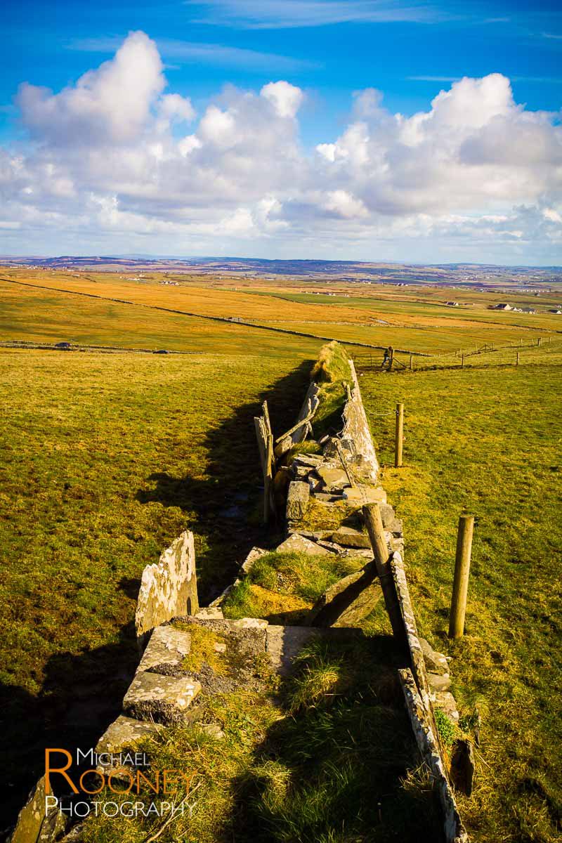 Old stone wall grass cliffs of moher ireland sunny