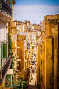 steep narrow alley street historic tourism malta valletta sunny
