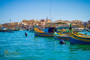 harbor bay water sunny colorful tourism historic fishing boats marsaxlokk malta