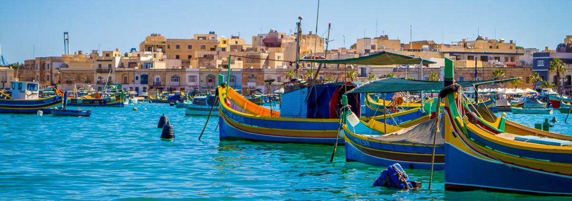harbor bay water sunny colorful tourism historic fishing boats marsaxlokk malta