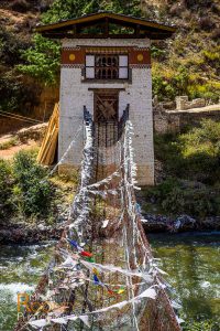 iron chain bridge suspension water old historic river paro chu tachog lhakhang bhutan pray flags