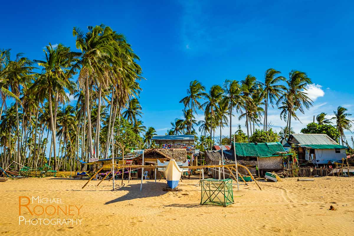 boat beach palm tree maintenance repair nacpan beach el nido palawan philippines